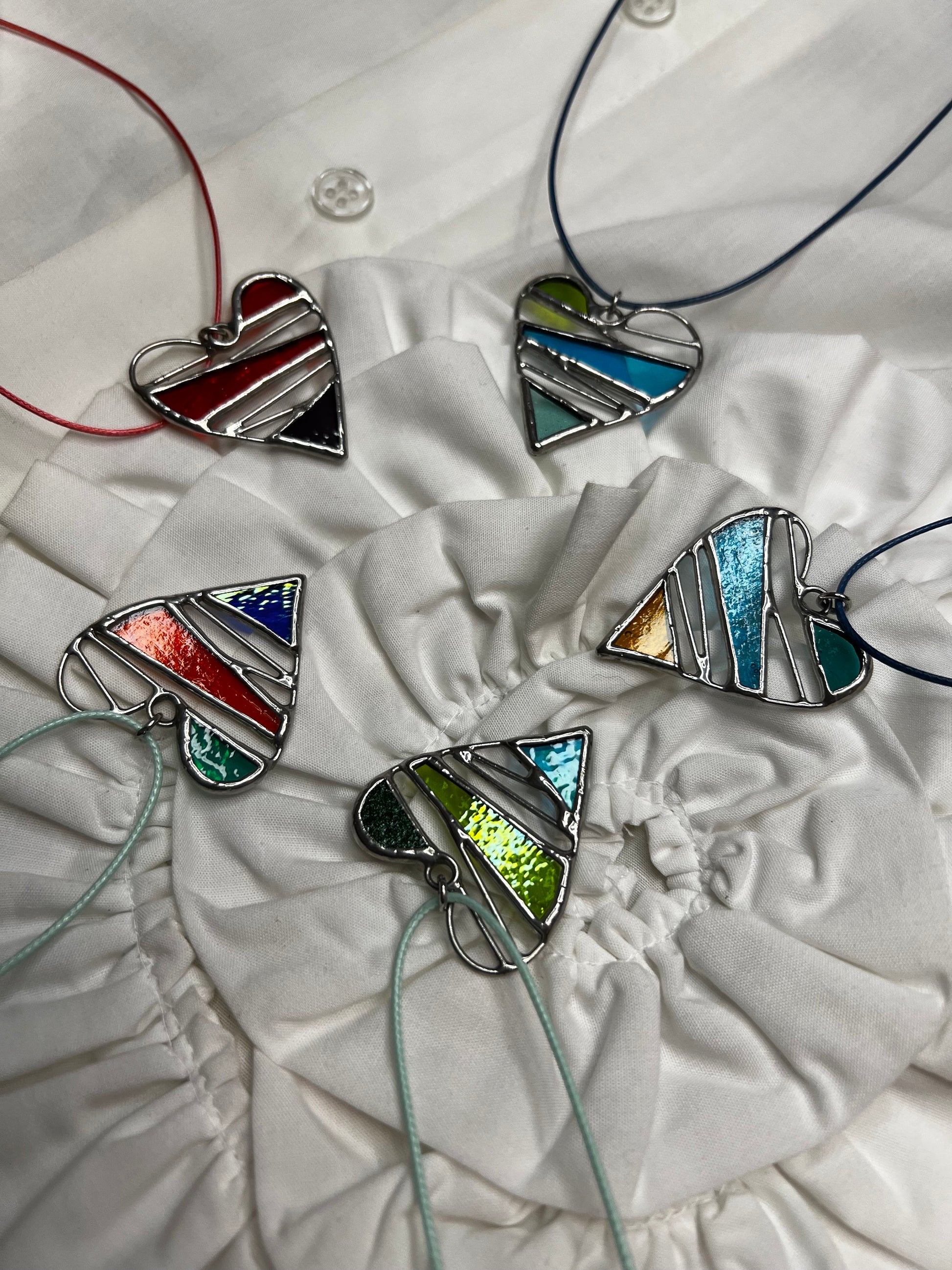 Colorful heart glass necklaces displayed together for Valentine gift
