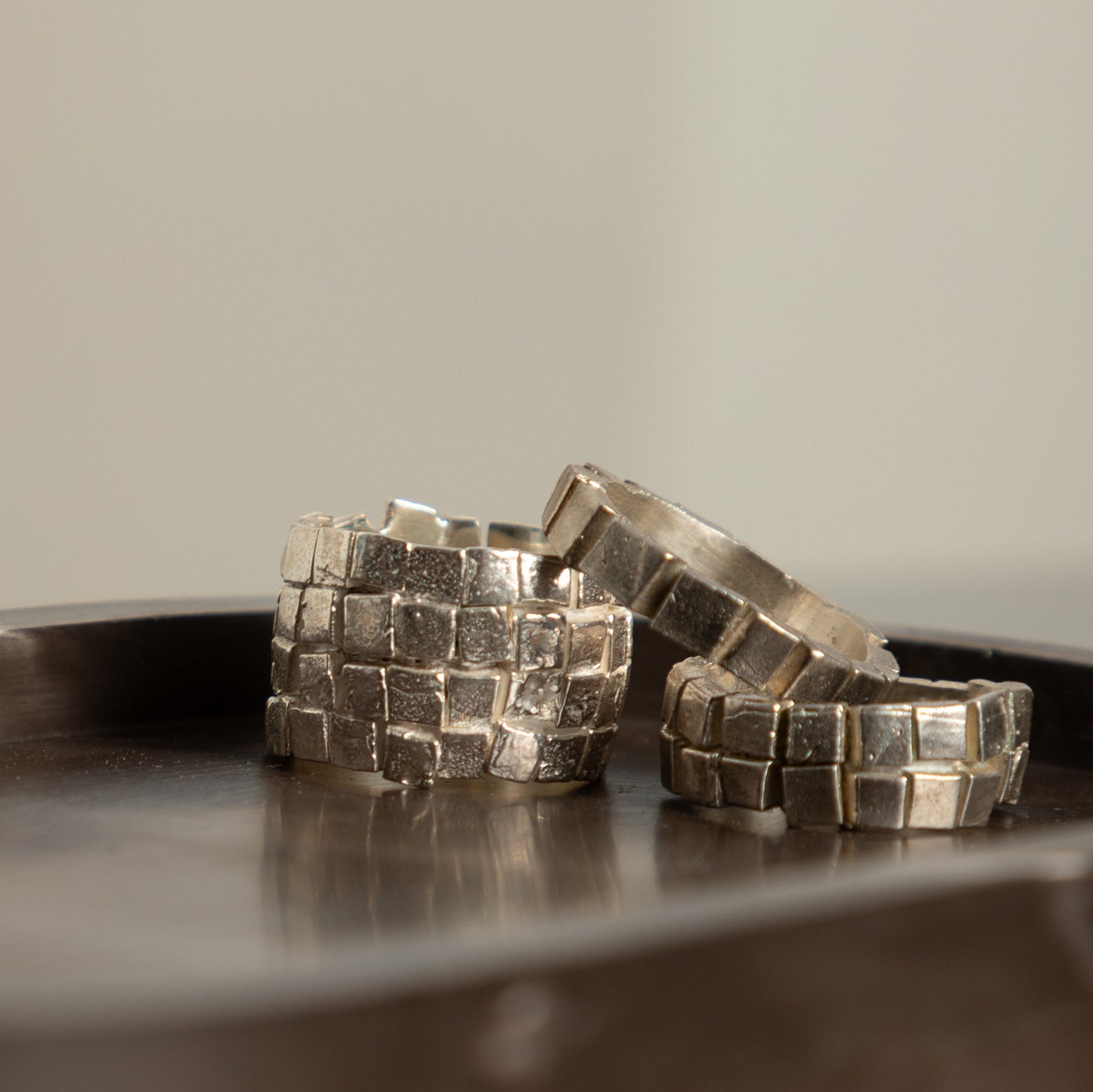 Silver rings on metallic tray – handmade unisex jewelry set