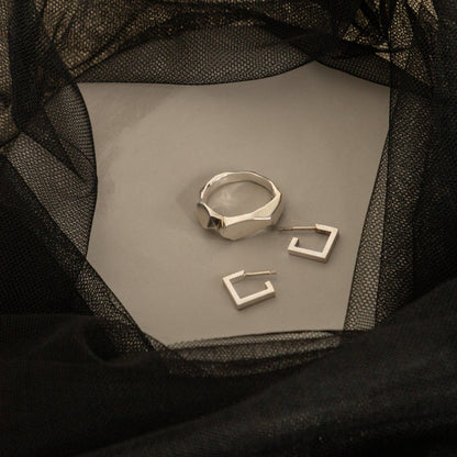 Silver stud earrings flatlay geometric jewelry