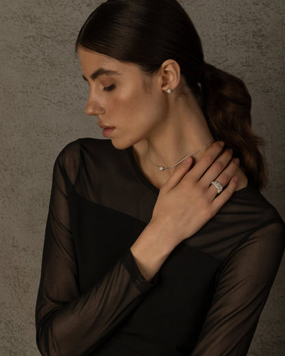 Woman wearing silver textured ring with black outfit