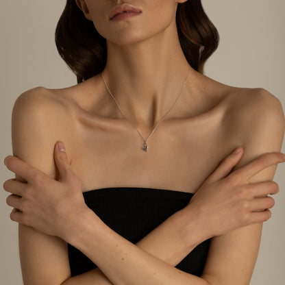 Minimal sterling silver heart necklace on model neck