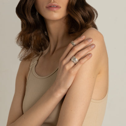 Woman wearing wide silver ring – minimalist architectural style