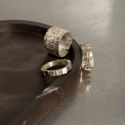 Set of chunky silver rings on tray – handmade artisan jewelry