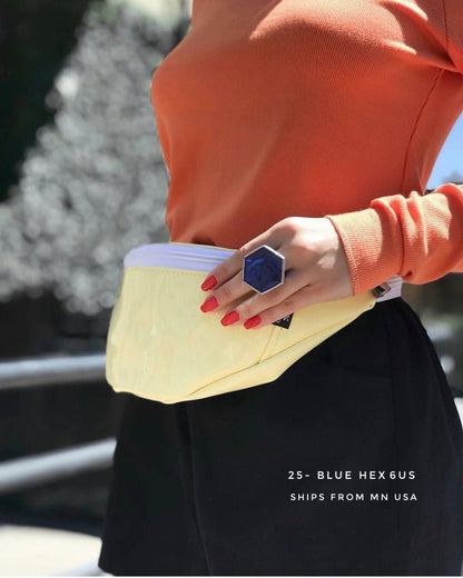 woman wearing big blue hexagon  ring outdoors