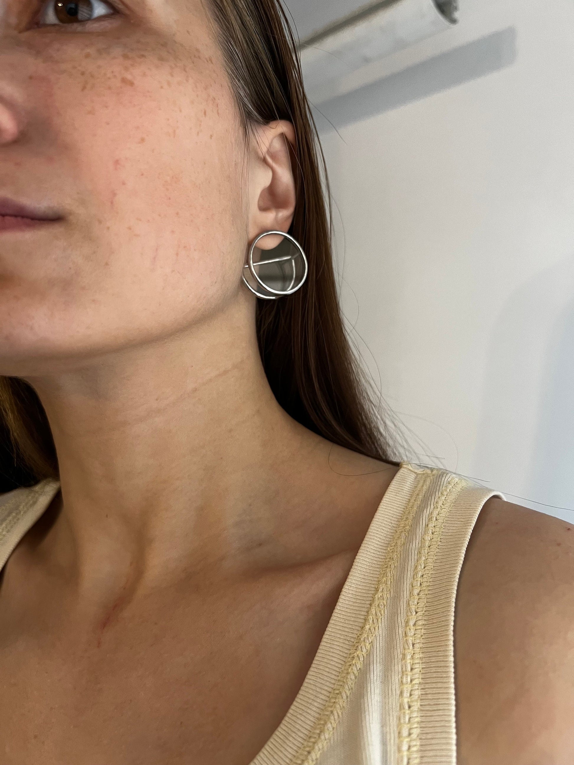 Side view of unique semi-circle stained glass studs on ear