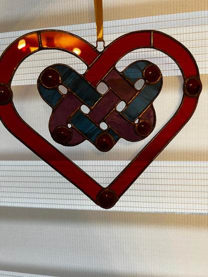 Red heart glass suncatcher catching sunlight