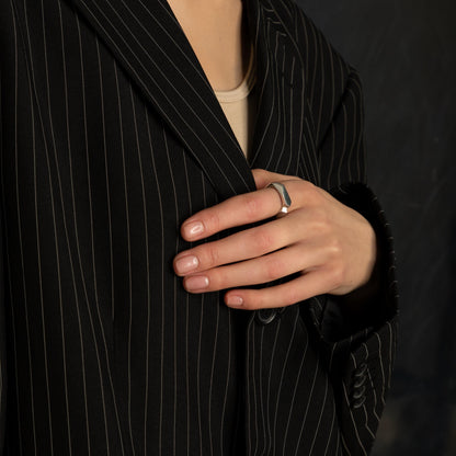 Silver band ring on a woman’s hand – fashionable minimalist accent