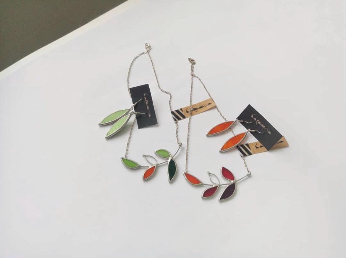 Close-up of, green and orange glass leaf earrings