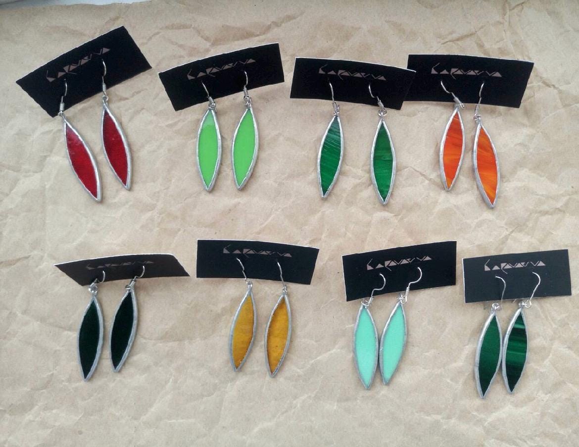 Stained glass leaf earrings in multiple colors on display cards