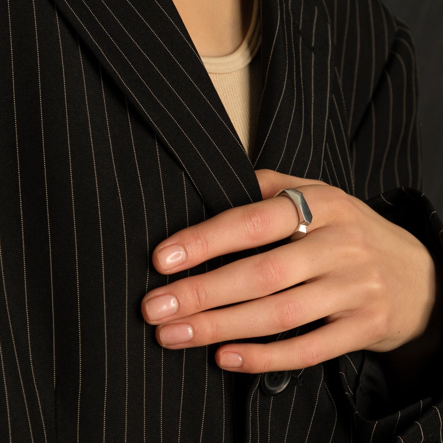 Textured sterling silver ring on woman’s hand, organic unisex band