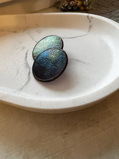 Shiny textured glass earrings reflecting light