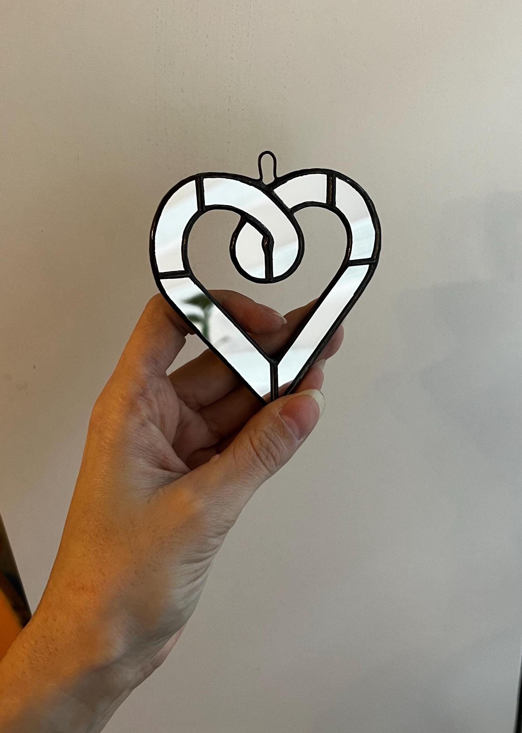 Stained glass heart suncatcher with mirror glass in hand