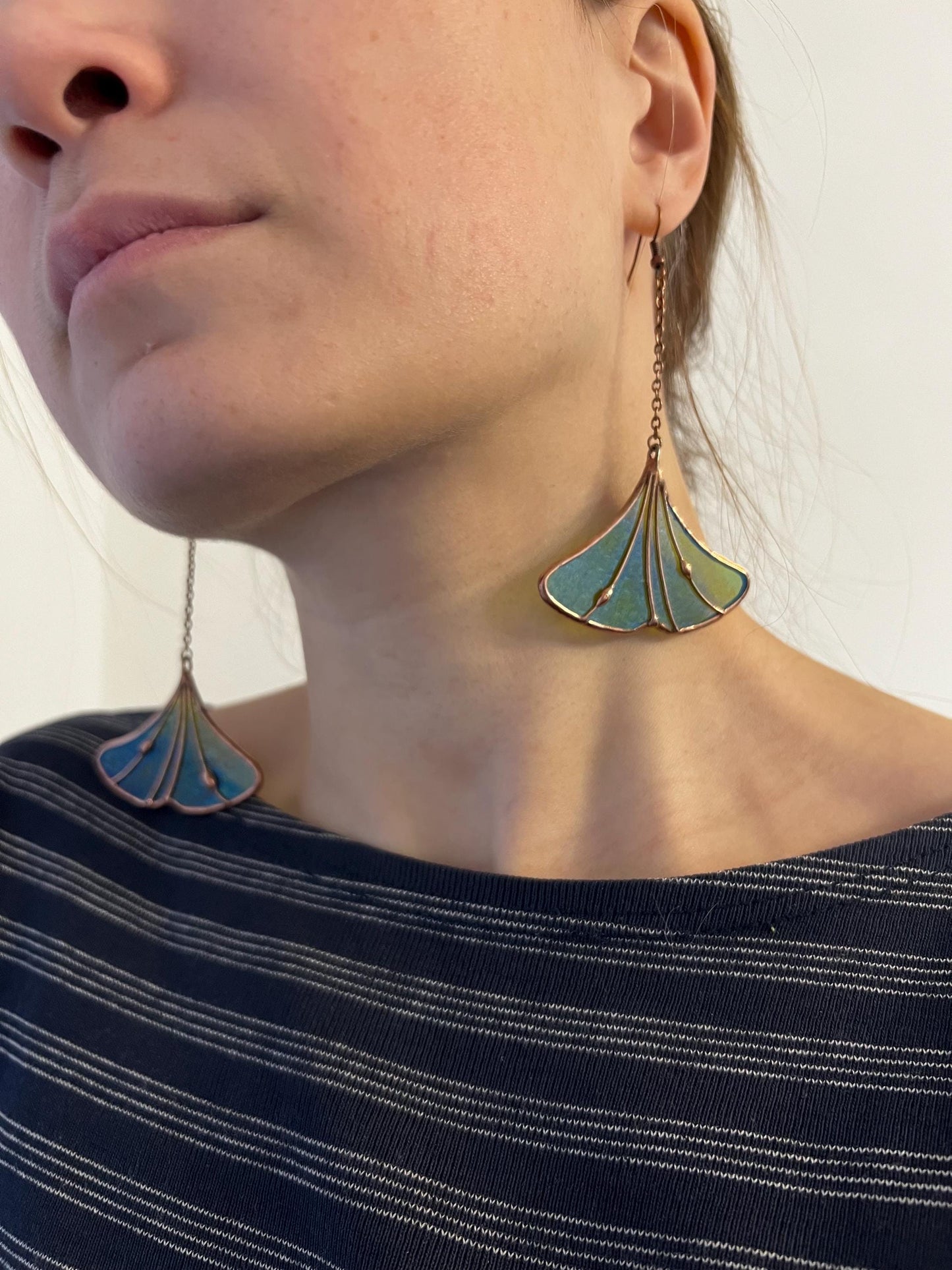 Model wearing blue stained glass ginkgo leaf necklace
