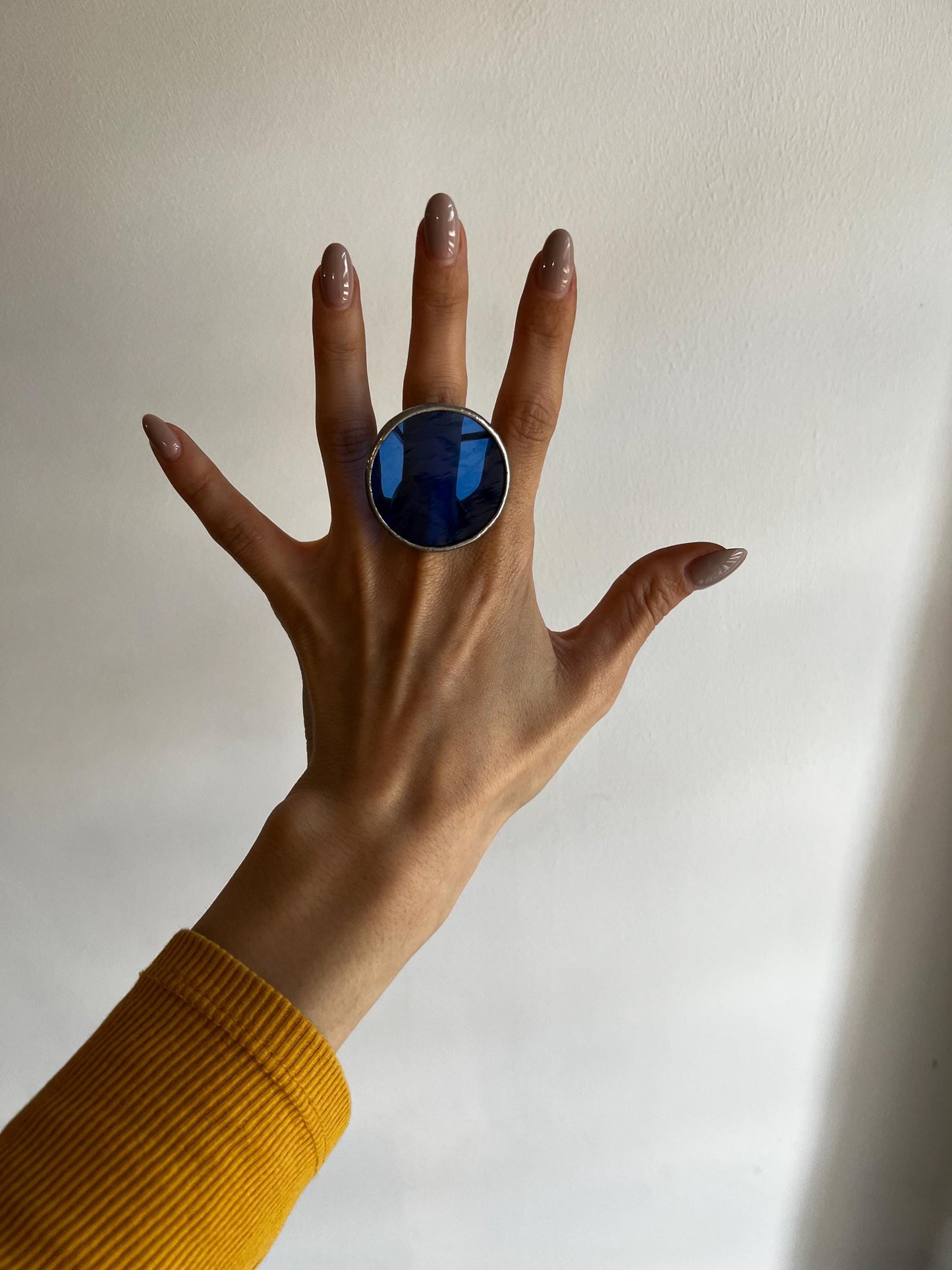 Statement ring with translucent blue disc in geometric design