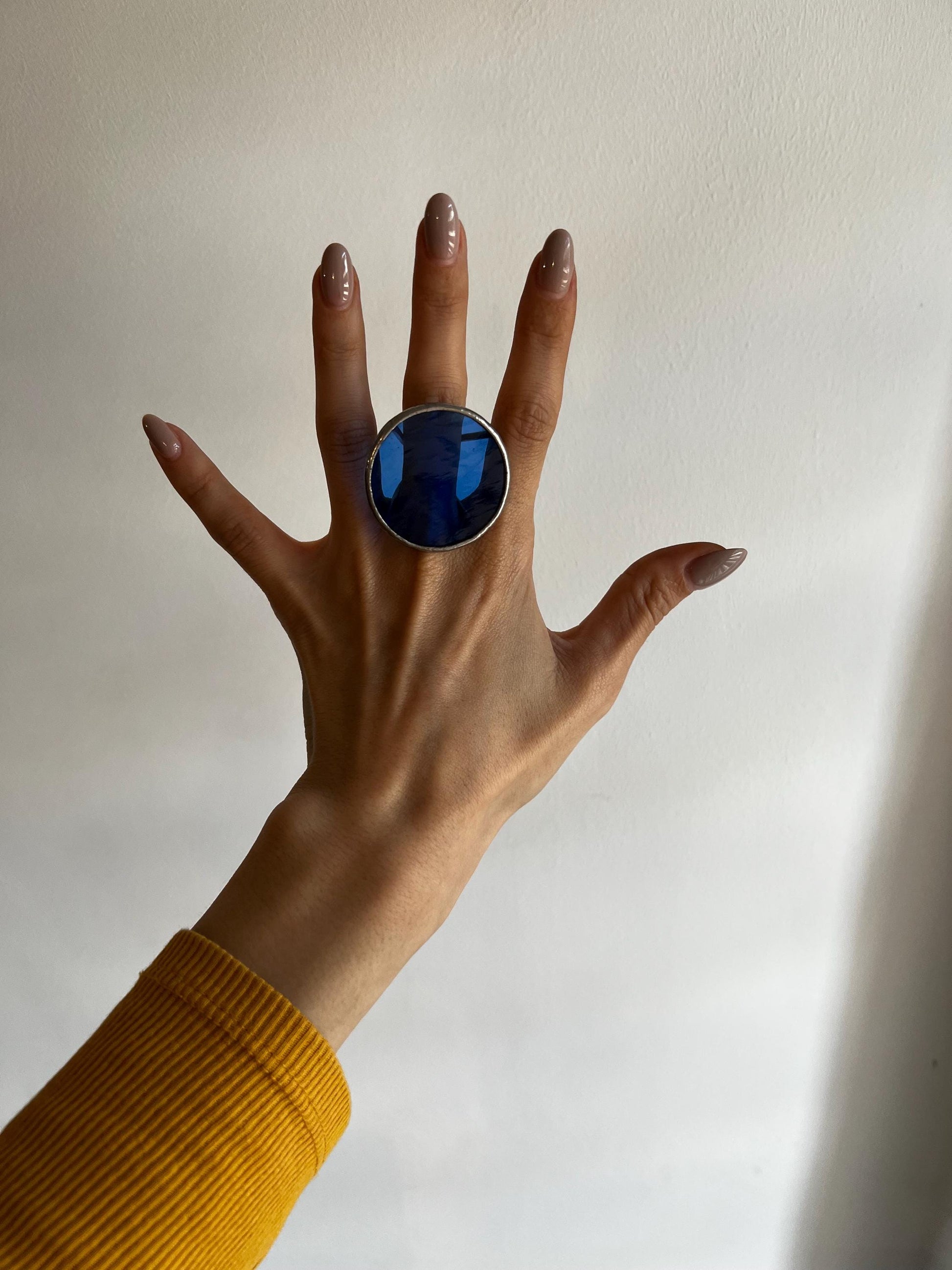 Statement ring with translucent blue disc in geometric design