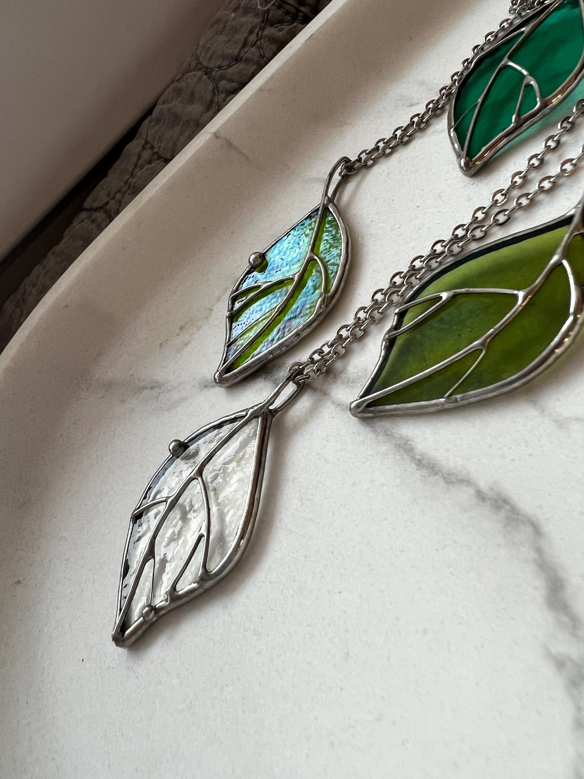 Unique handmade green glass leaf necklace with delicate silver chain.