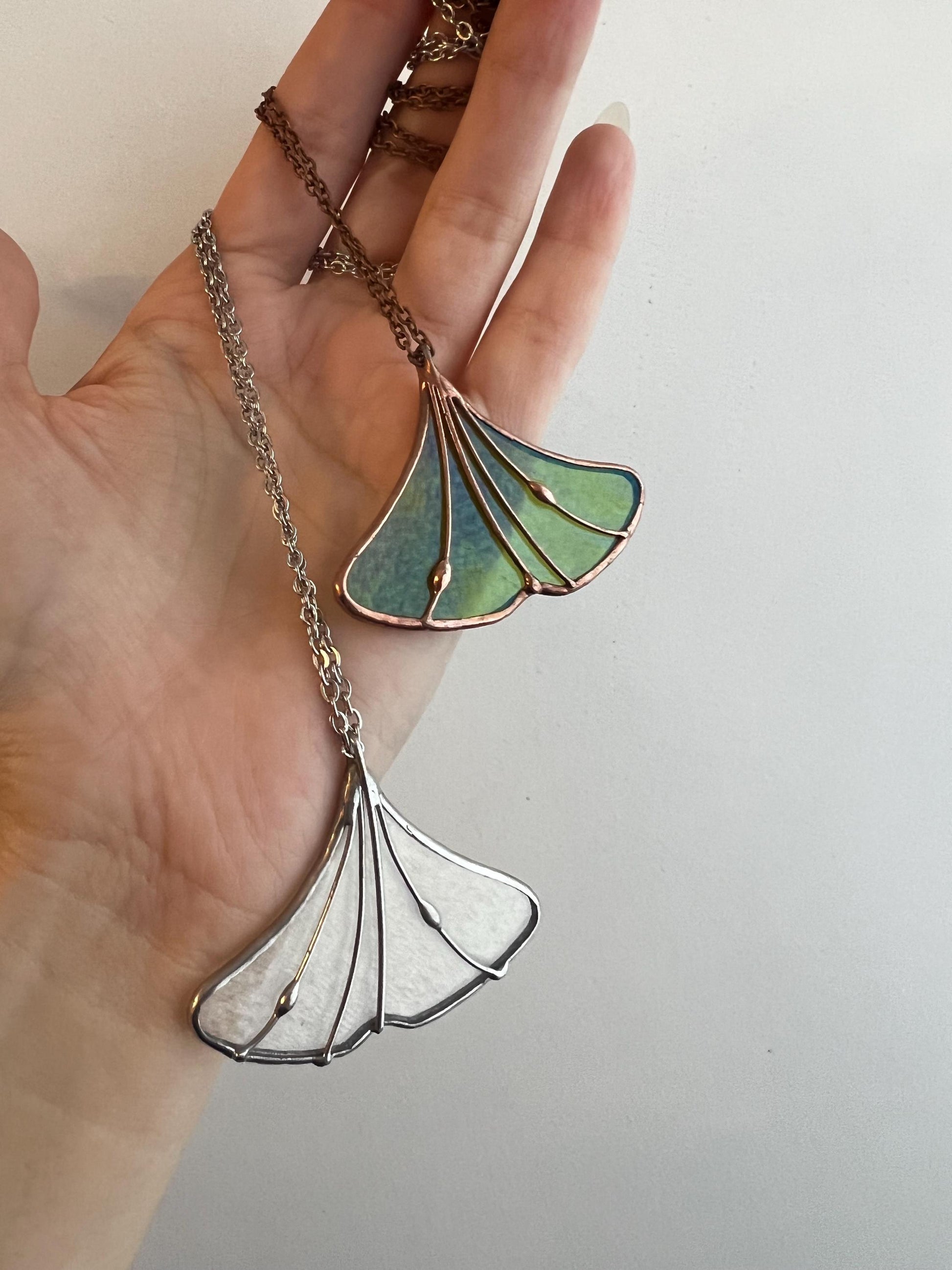 Green stained glass ginkgo leaf necklace on chain – close-up