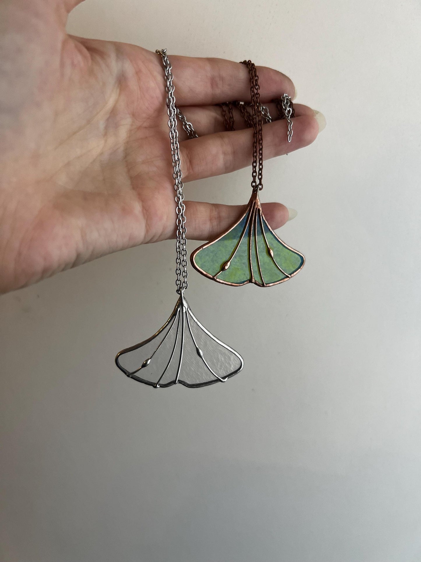 Two ginkgo leaf stained glass pendants on chain – green and clear