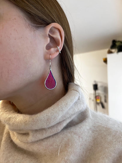Artistic teardrop earrings with iridescent glass close up