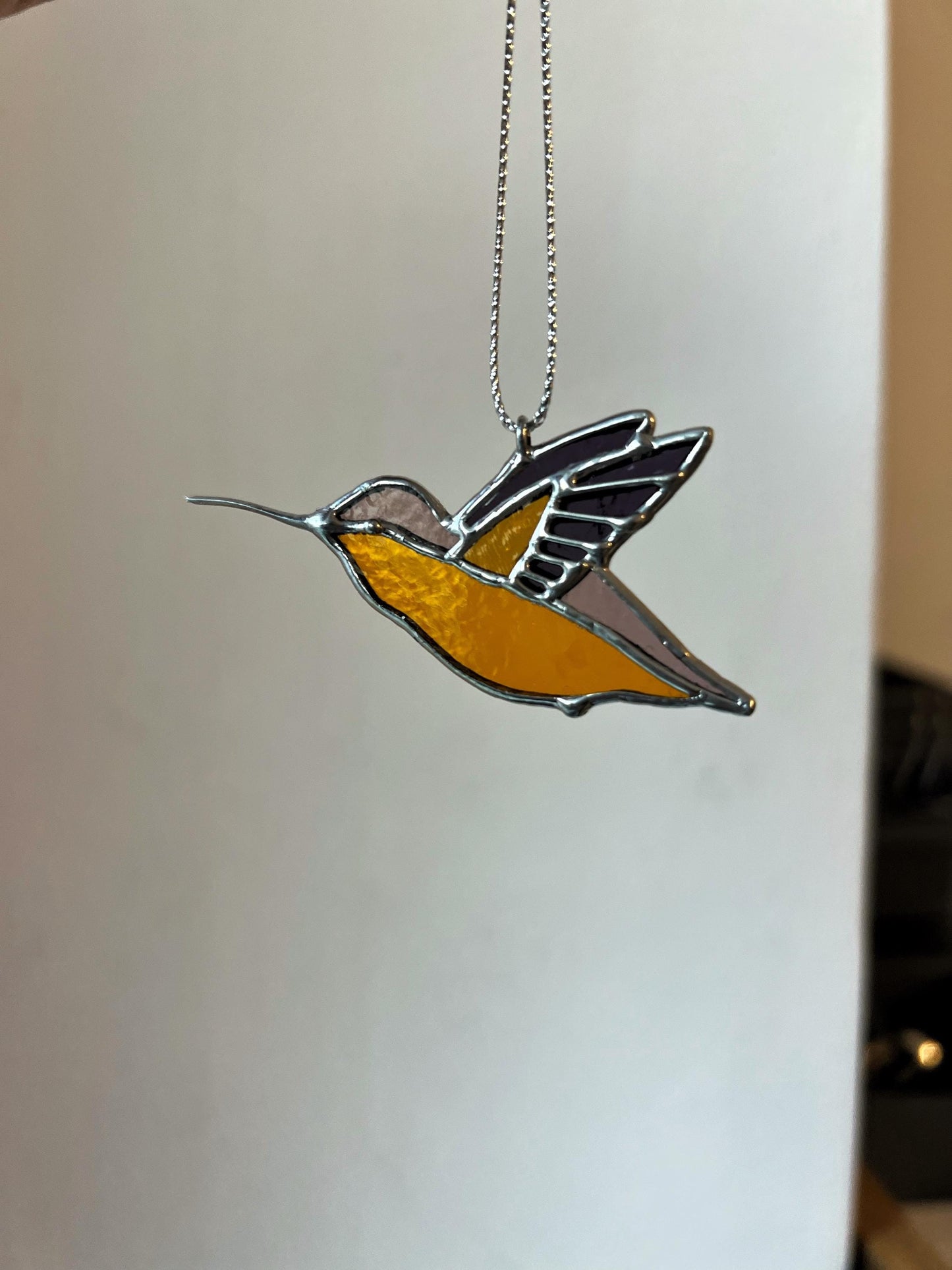 Yellow orange stained glass hummingbird ornament on chain