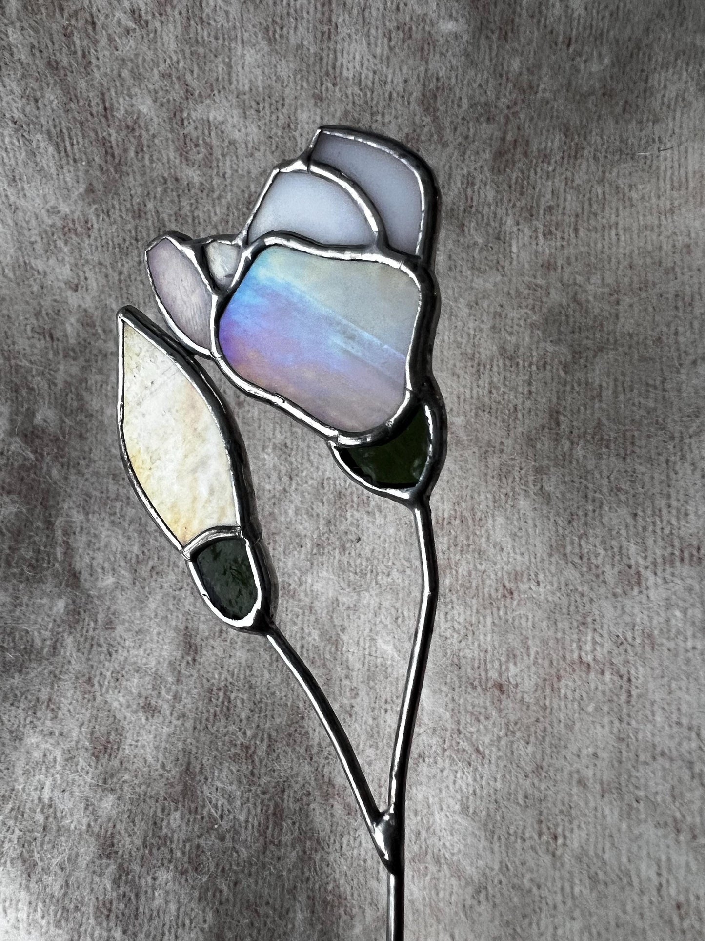 Glass magnolia with opal and yellow petals reflecting natural light