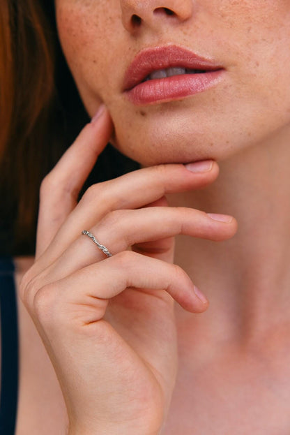 Silver hammered ring close-up on background.