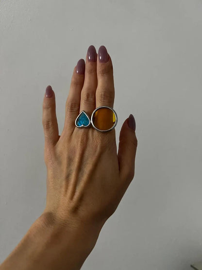 Modern set of geometric stained glass rings in blue heart and yellow disk.