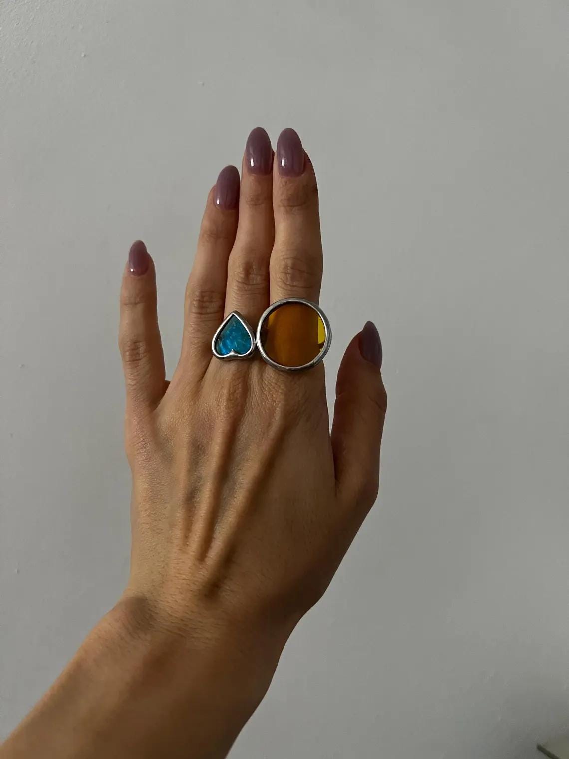 Blue and yellow stained glass heart ring on hand, geometric handmade jewelry