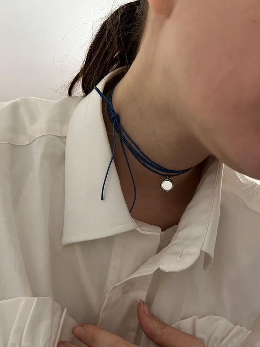 Mirror choker necklace on dark blue cord close-up