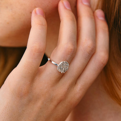 Woman wearing textured silver disk ring – elegant engagement style hand pose