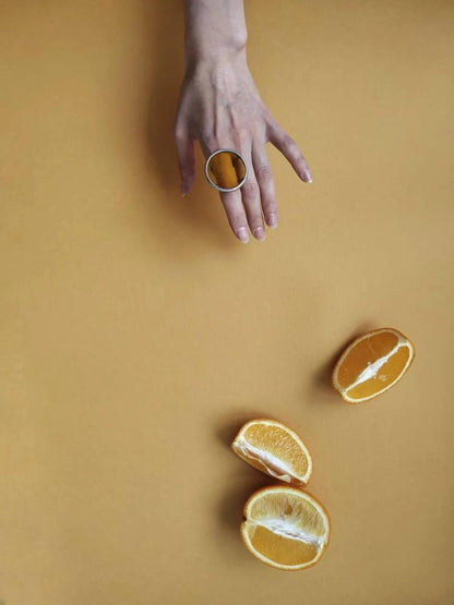 Chunky yellow stained glass ring with round disk shape. Geometric handmade jewelry with bold modern design.