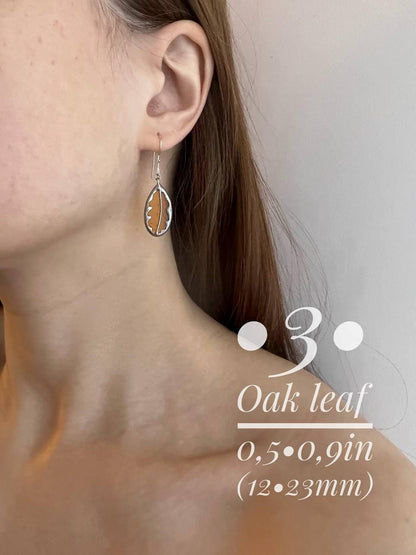 Oak and birch leaf stained glass earrings size comparison on model