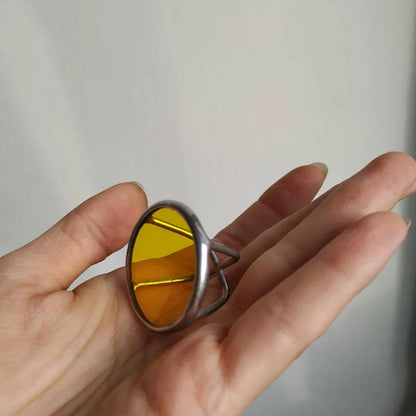 Chunky yellow stained glass ring with round disk shape. Geometric handmade jewelry with bold modern design.