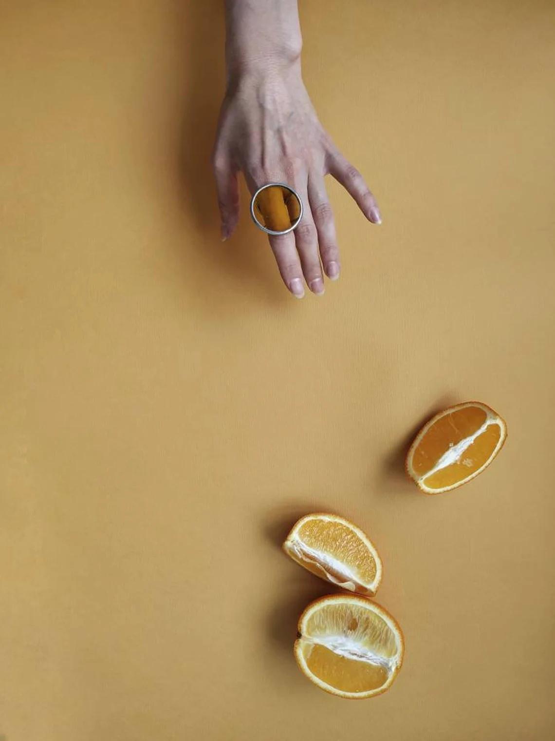 Bold geometric glass ring worn on hand