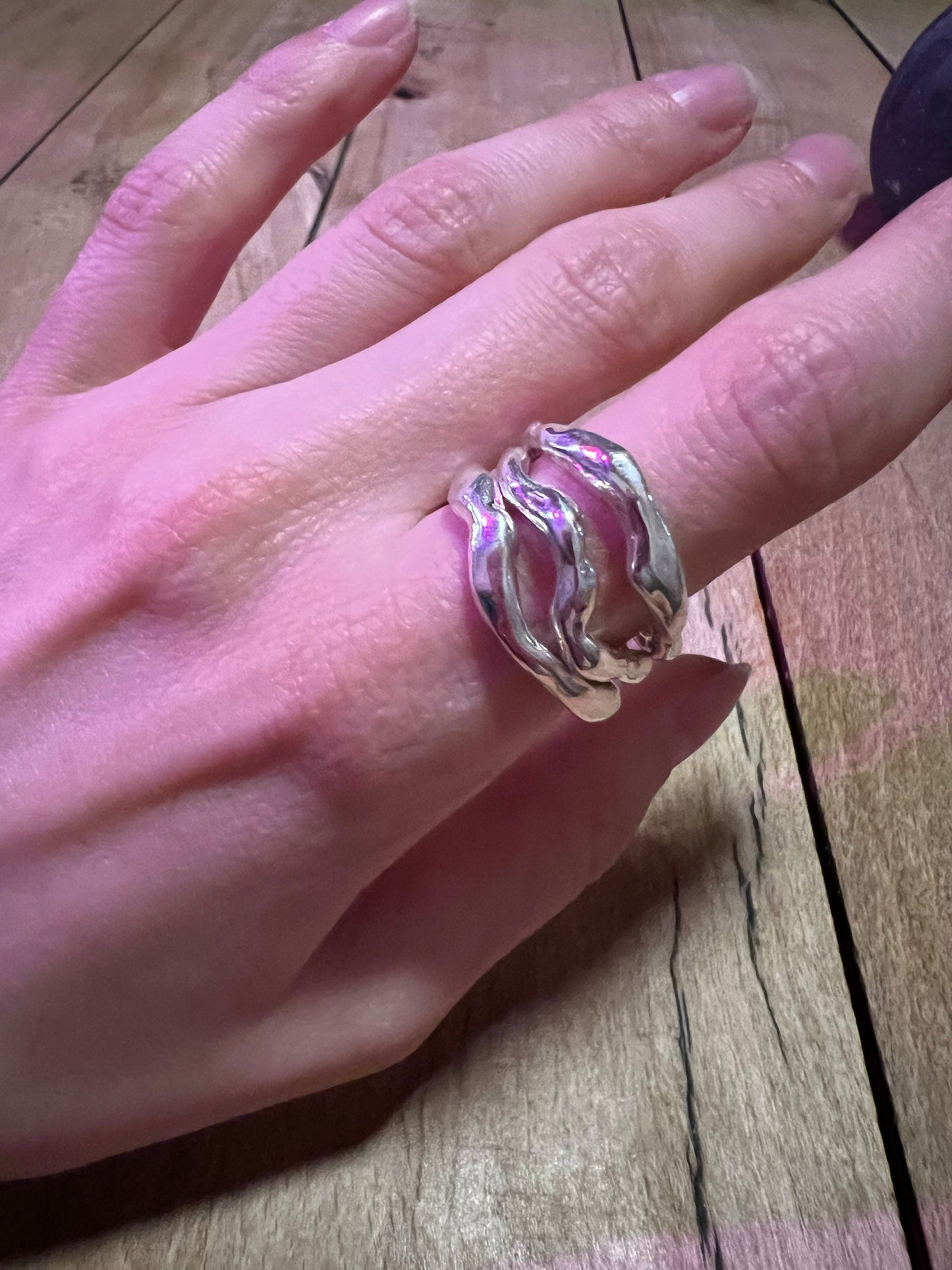 Massive wavy 925 silver rings on the hand – liquid metal style. Set of 3