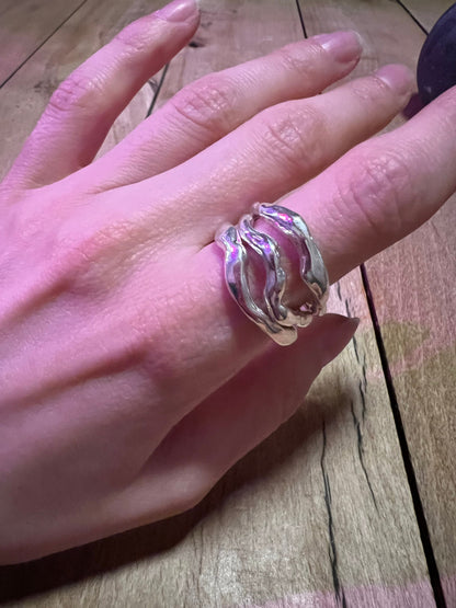 Massive wavy 925 silver rings on the hand – liquid metal style. Set of 3