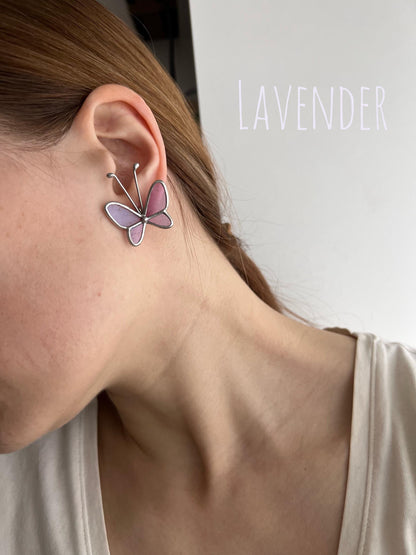 Display of lavender butterfly earrings on ear