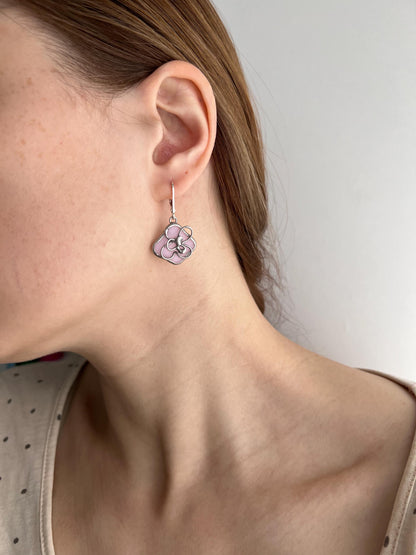 Close-up of pink dangle earrings inspired by sakura flowers, botanical spring jewelry