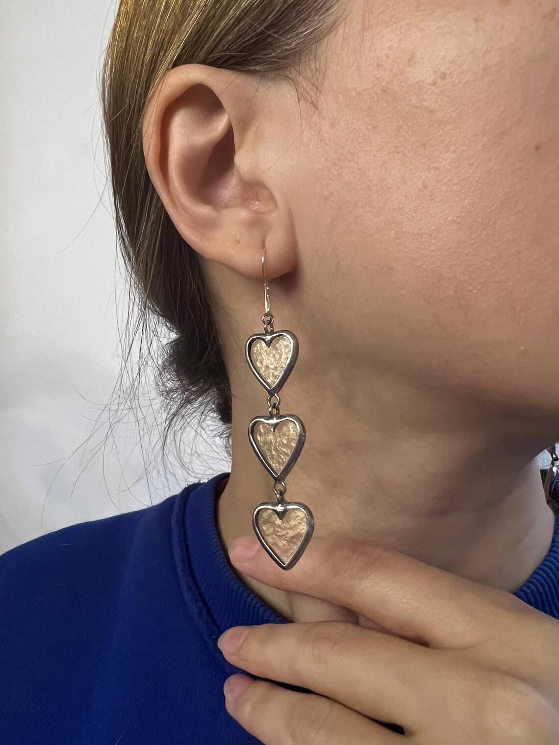 Valentine heart earrings worn with blue sweater