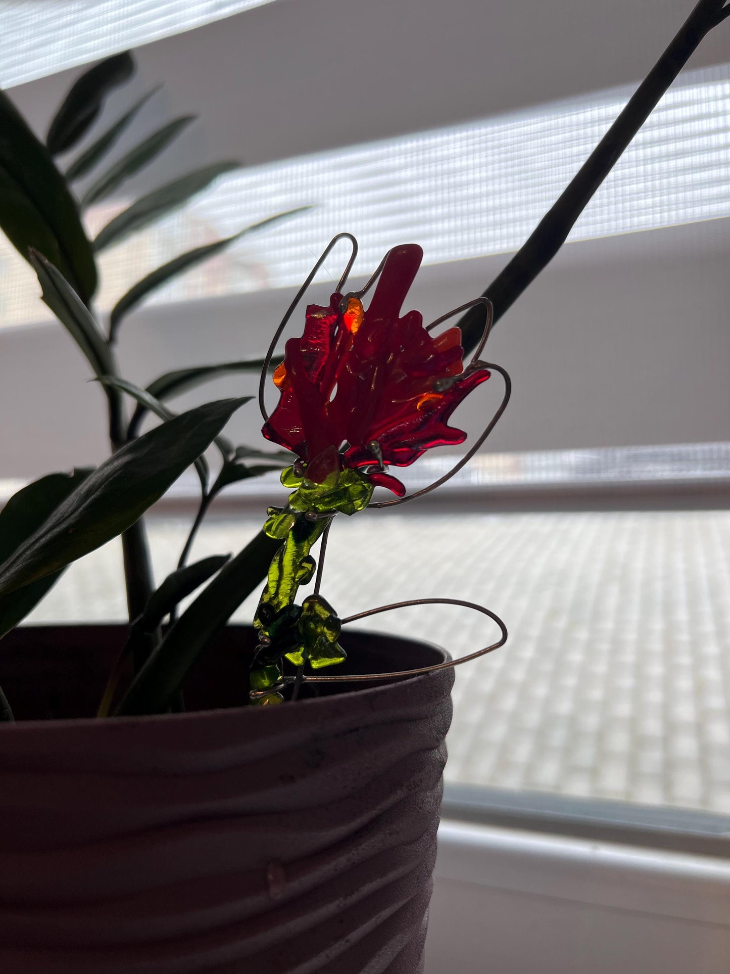 Eco-friendly fused glass flower decor used as plant ornament