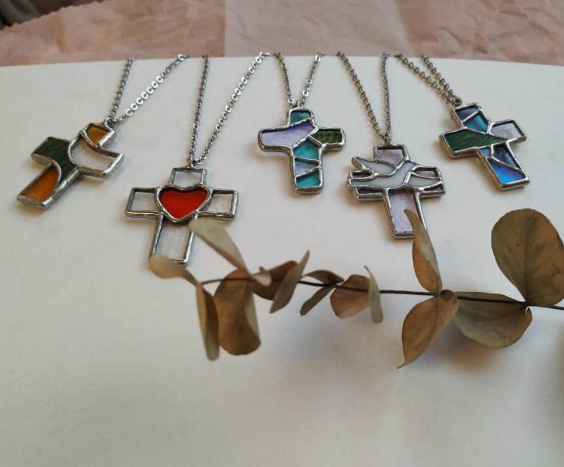 Artistic display of multiple crosses necklaces with dried branch decor