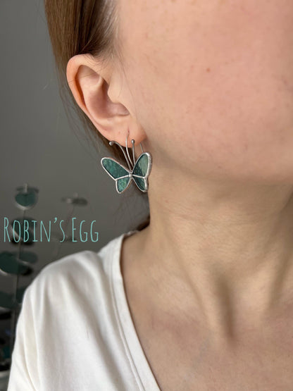 Display of robin's egg butterfly earrings on ear