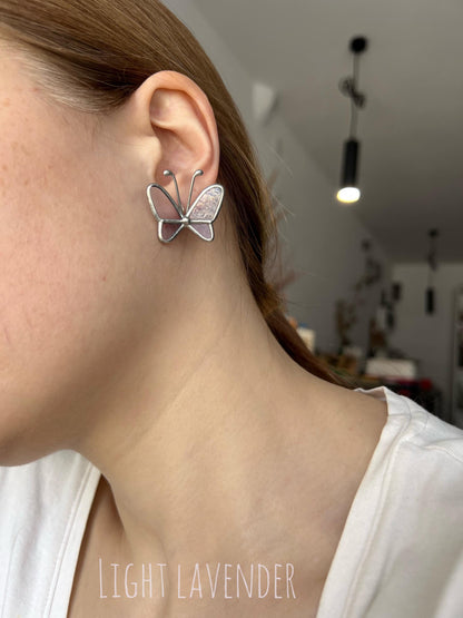 Light lavender stained glass butterfly earrings worn