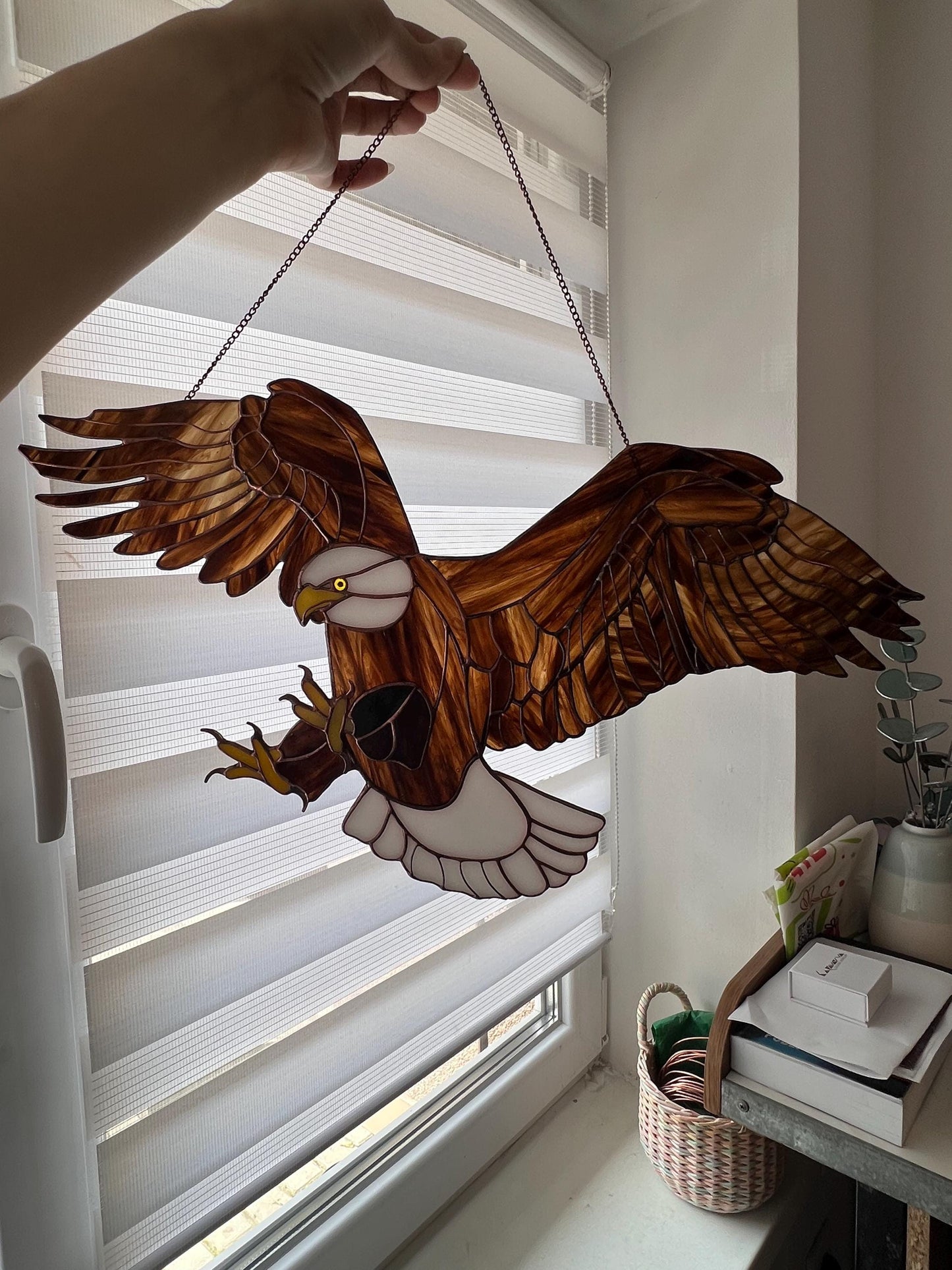 Eagle glass suncatcher catching sunlight in window