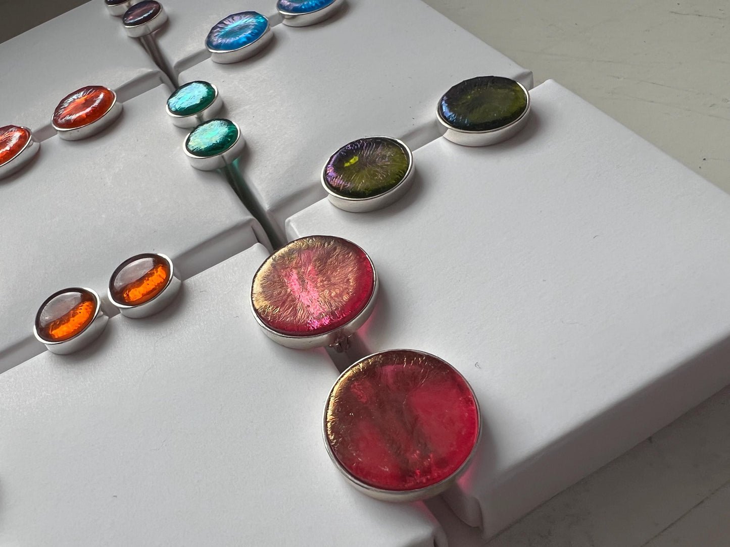 Close-up of fused-glass studs with glossy surface