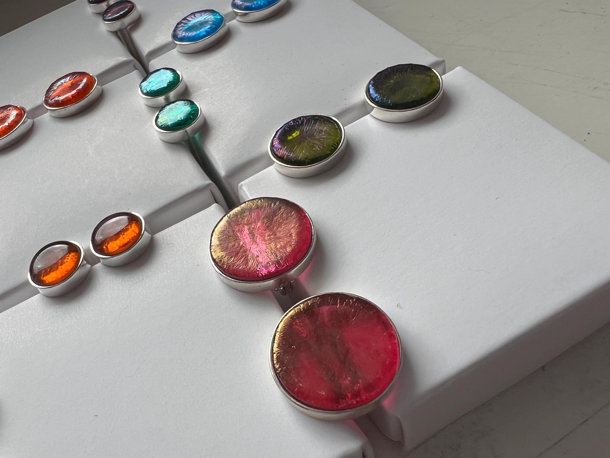 Close-up of fused-glass studs with glossy surface