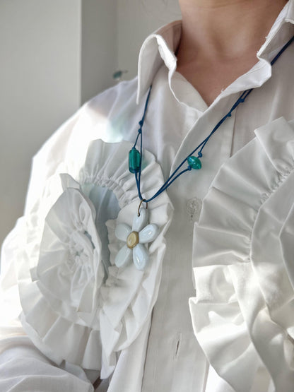 white fused glass flower necklace on model