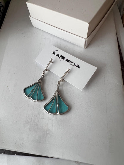 Handmade stained glass earrings shaped like ginkgo leaves, mint color with silver findings, nature-inspired dangle design.