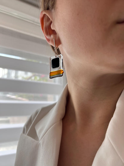 Modern fused glass earrings with sterling silver hooks, featuring geometric rectangular design in contrasting glossy black and amber brown tones