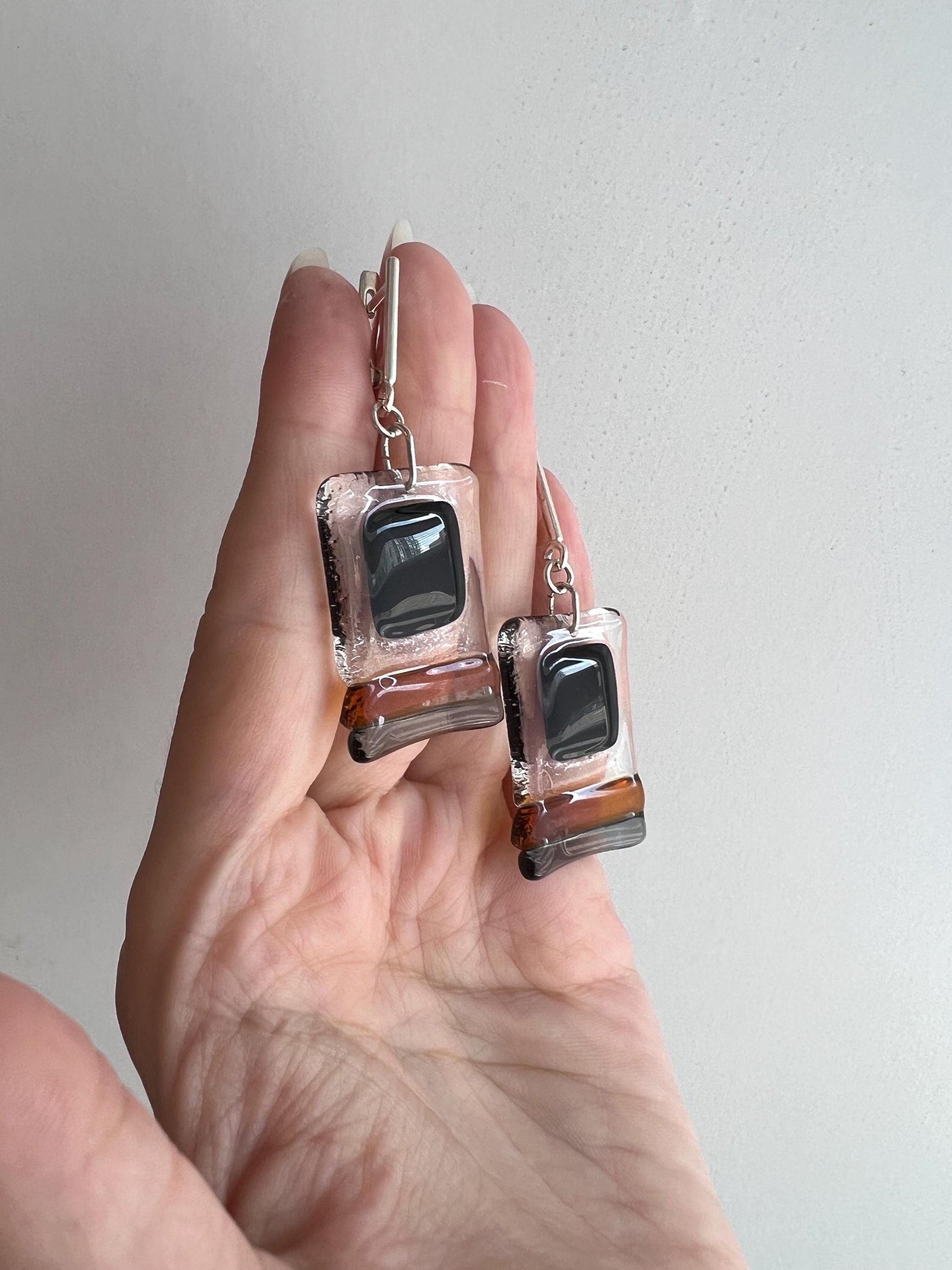 Modern fused glass earrings with sterling silver hooks, featuring geometric rectangular design in contrasting glossy black and amber brown tones